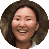 Young happy laughing asian woman walking in city